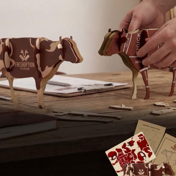 BRANDCRAFT wooden cow models being assembled on a workbench